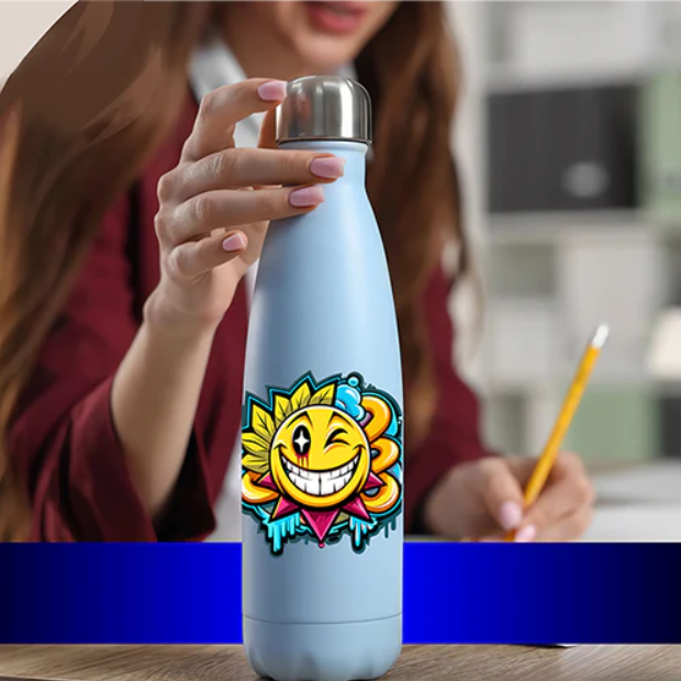 Close-up of a woman holding a blue water bottle with a colorful UV DTF smiley sun decal, featuring a wink and dripping paint style in an office setting.